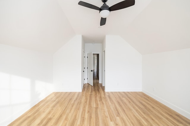 bonus room with lofted ceiling, light wood finished floors, baseboards, and a ceiling fan