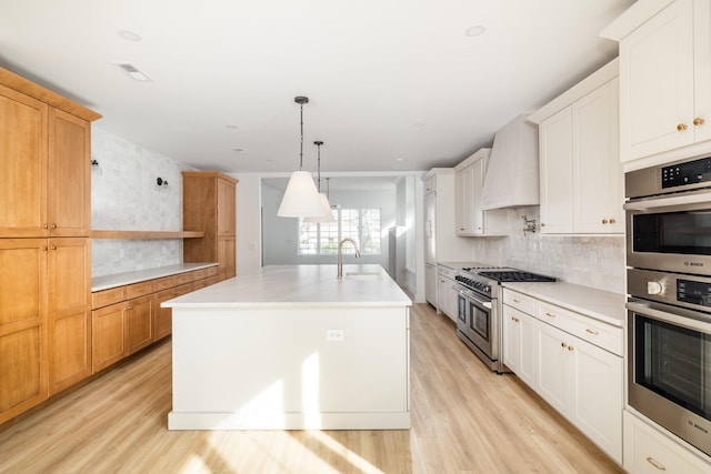 kitchen with appliances with stainless steel finishes, light countertops, custom exhaust hood, and open shelves