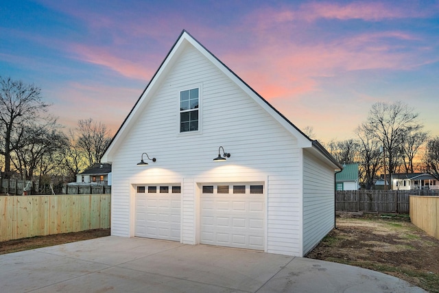 garage with a detached garage and fence