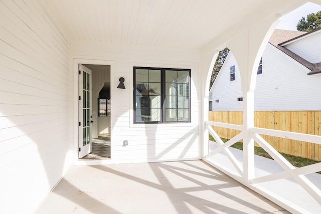 entrance to property with fence and a patio