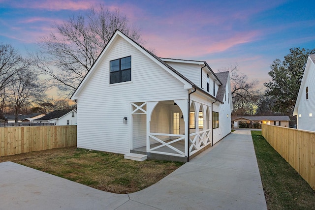 exterior space with fence and a lawn