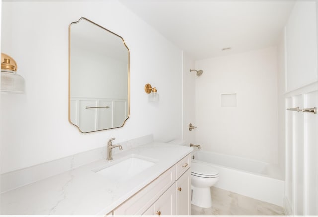 bathroom featuring toilet, vanity, and shower / bathing tub combination