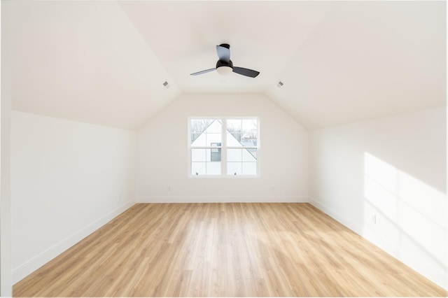 bonus room featuring lofted ceiling, ceiling fan, light wood-style flooring, and baseboards