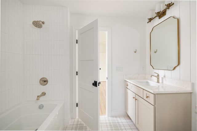 bathroom featuring tile patterned flooring, shower / bathing tub combination, baseboards, and vanity