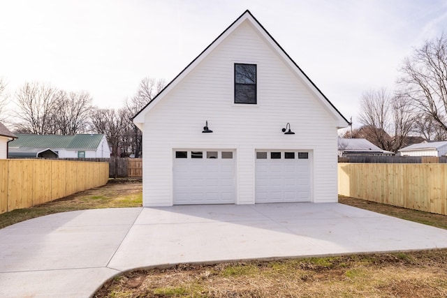 garage with a garage and fence