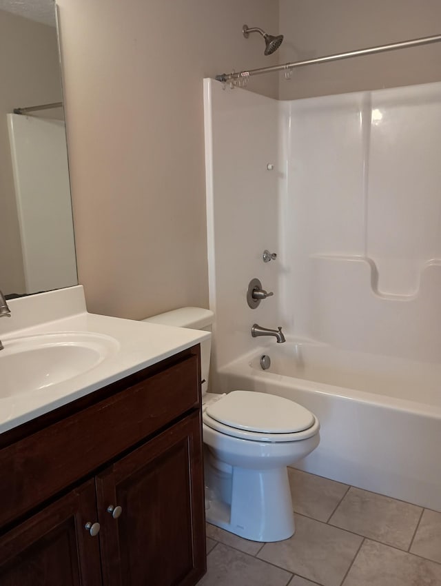 bathroom with toilet, vanity, tile patterned flooring, and washtub / shower combination