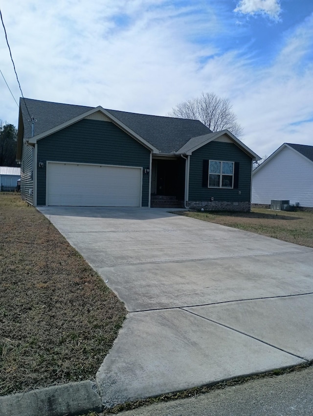 ranch-style home featuring a garage and concrete driveway