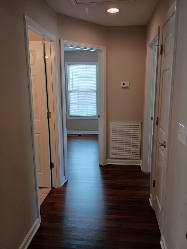 hallway with recessed lighting, visible vents, attic access, wood finished floors, and baseboards