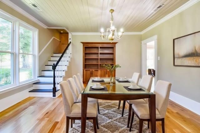 3635 Old Williamsport Rd, Williamsport, TN 38487 - dining space with a chandelier, light wood-type flooring, stairs, and crown molding