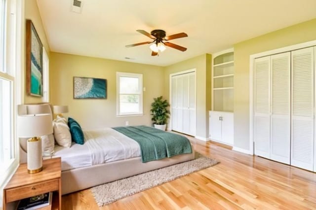 3635 Old Williamsport Rd, Williamsport, TN 38487 - bedroom featuring ceiling fan, wood finished floors, visible vents, and multiple closets
