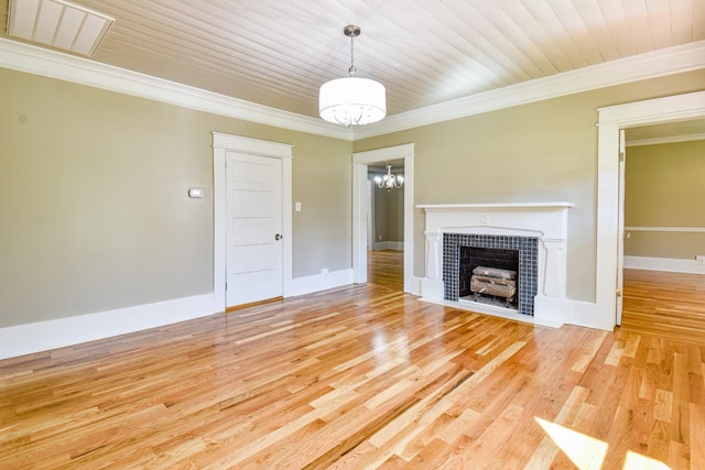 3635 Old Williamsport Rd, Williamsport, TN 38487 - unfurnished living room with a notable chandelier, visible vents, a tiled fireplace, ornamental molding, and light wood-style floors
