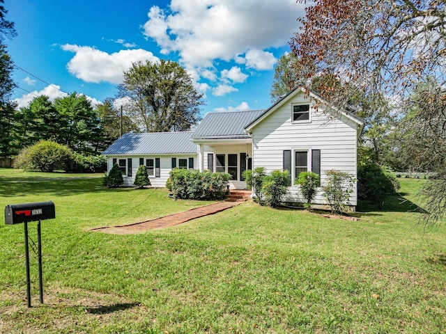 3635 Old Williamsport Rd, Williamsport, TN 38487 - view of front of home with a front yard, a standing seam roof, and metal roof