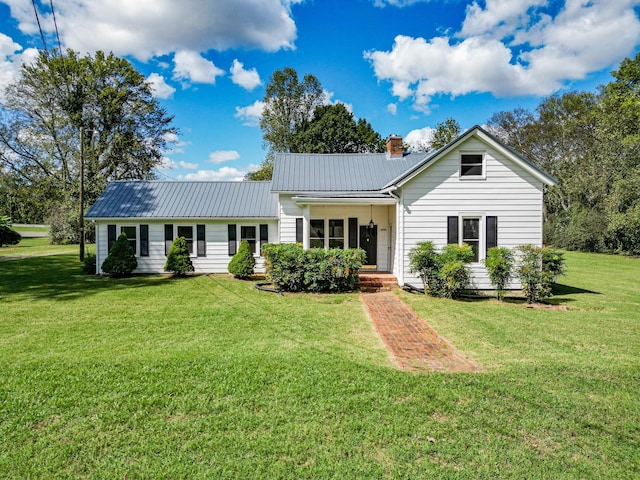 3635 Old Williamsport Rd, Williamsport, TN 38487 - exterior space with metal roof, a chimney, and a front lawn