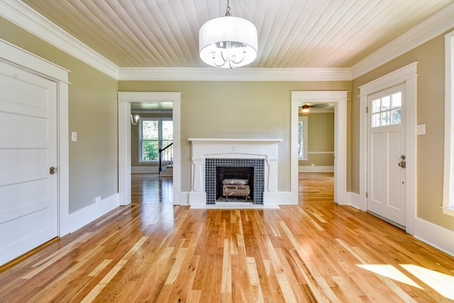 3635 Old Williamsport Rd, Williamsport, TN 38487 - unfurnished living room featuring ornamental molding, wood ceiling, a tiled fireplace, and light wood finished floors