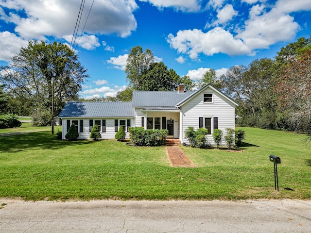 3635 Old Williamsport Rd, Williamsport, TN 38487 - ranch-style home with a front yard, metal roof, and a chimney