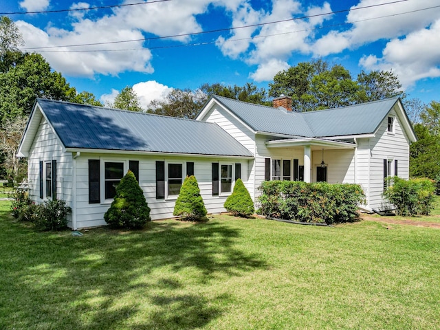 3635 Old Williamsport Rd, Williamsport, TN 38487 - single story home featuring a chimney, metal roof, and a front yard