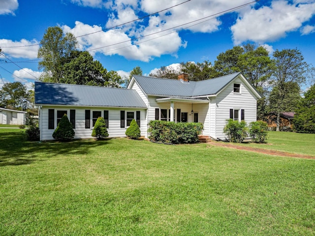 3635 Old Williamsport Rd, Williamsport, TN 38487 - single story home with metal roof, a front lawn, and a chimney