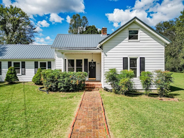 3635 Old Williamsport Rd, Williamsport, TN 38487 - view of front of home featuring metal roof, a chimney, and a front lawn