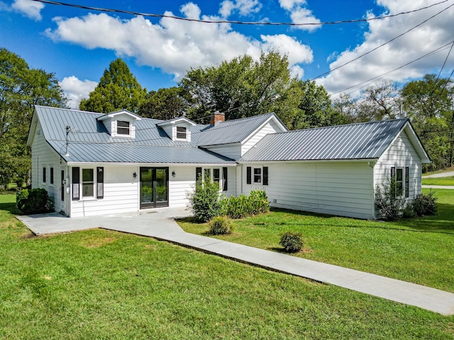 3635 Old Williamsport Rd, Williamsport, TN 38487 - back of house featuring metal roof, a lawn, and a chimney