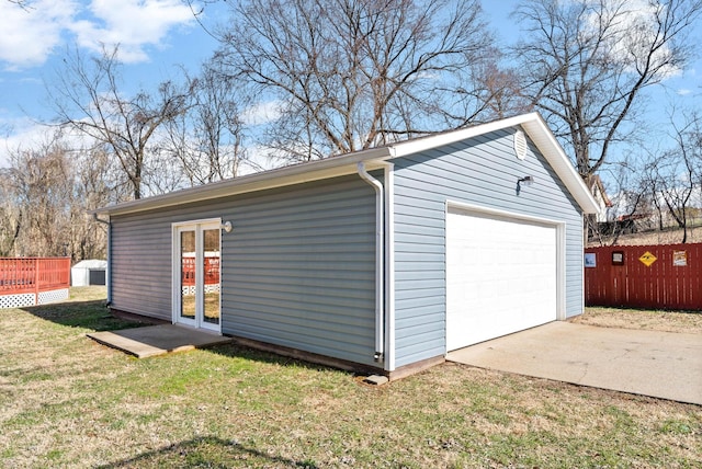 detached garage featuring fence