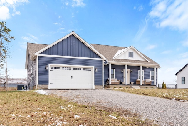 view of front of home with driveway, a garage, a shingled roof, covered porch, and board and batten siding