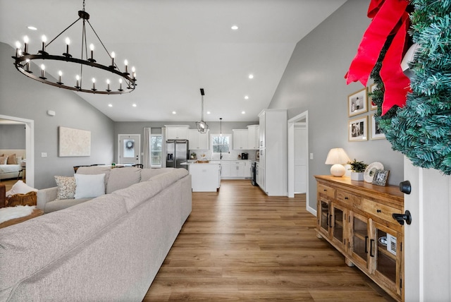 living room featuring light wood-style floors, high vaulted ceiling, and recessed lighting