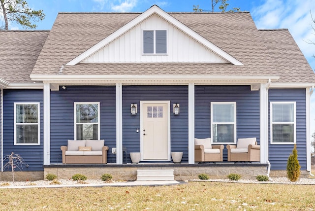 view of front of house with covered porch and a shingled roof