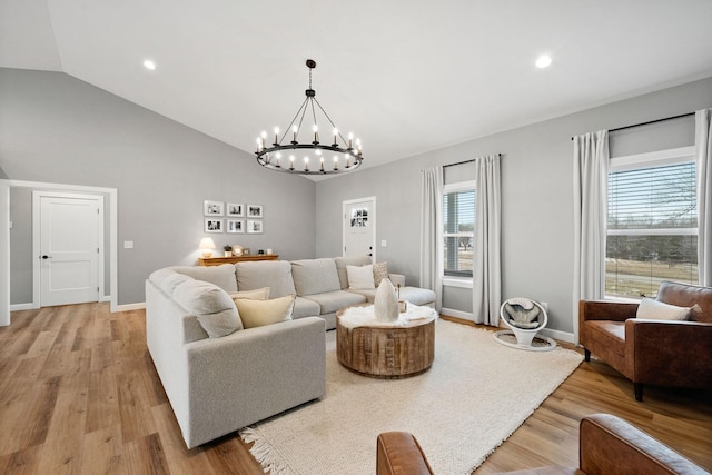 living room featuring vaulted ceiling, recessed lighting, light wood-style flooring, and baseboards