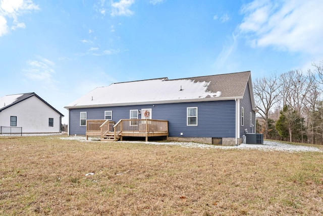 back of house with cooling unit, a lawn, and a wooden deck