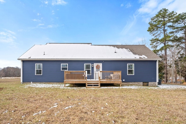 rear view of property featuring a yard and a wooden deck