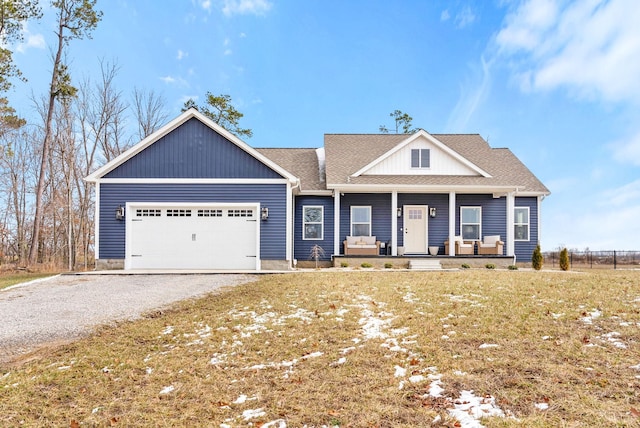 view of front facade featuring driveway, a garage, a shingled roof, a porch, and a front lawn