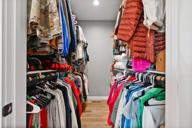 walk in closet featuring wood finished floors