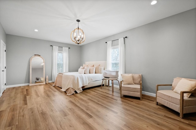 bedroom featuring light wood-style flooring, baseboards, a chandelier, and recessed lighting