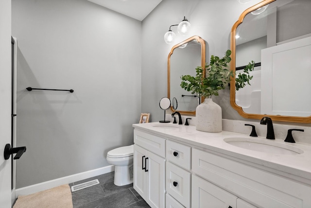 bathroom with baseboards, visible vents, a sink, and toilet