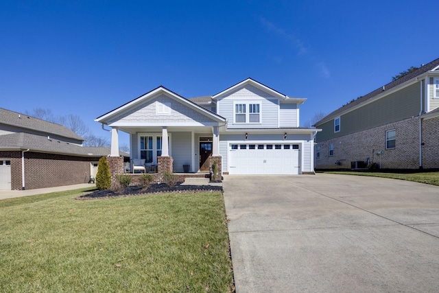 craftsman-style home with an attached garage, covered porch, concrete driveway, and a front yard