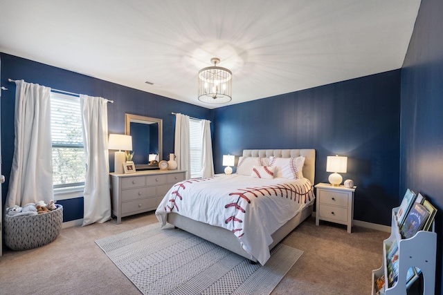 bedroom featuring carpet floors, baseboards, and an inviting chandelier