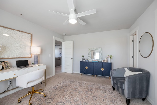 home office featuring carpet flooring, a ceiling fan, and baseboards