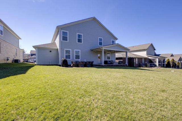 rear view of property featuring a yard, a patio area, and central air condition unit