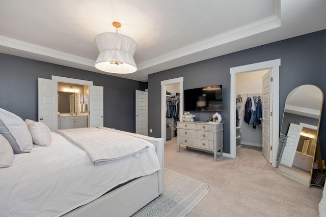 bedroom with arched walkways, ensuite bathroom, light carpet, ornamental molding, and a walk in closet