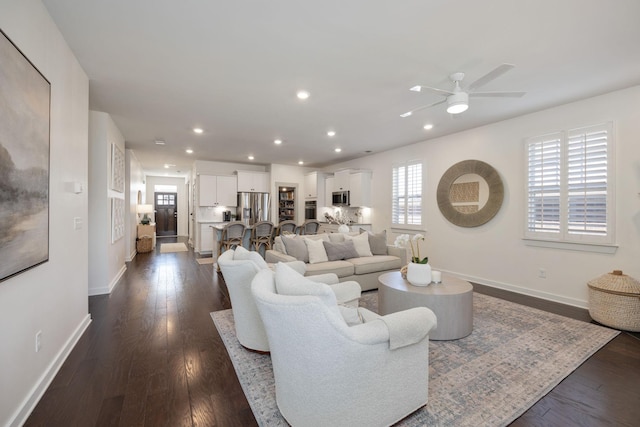 living room featuring dark wood-style floors, a wealth of natural light, baseboards, and recessed lighting