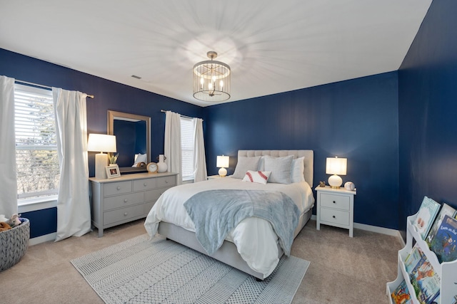 bedroom with light carpet, baseboards, and a notable chandelier