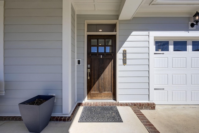 view of exterior entry with a garage