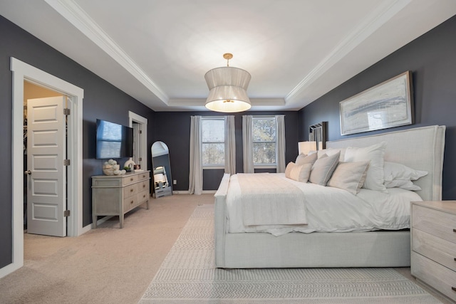 bedroom featuring crown molding, baseboards, a raised ceiling, and carpet flooring