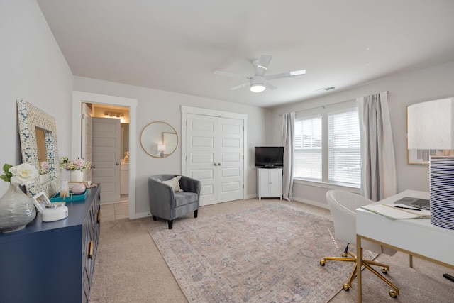 carpeted home office featuring a ceiling fan, visible vents, and baseboards