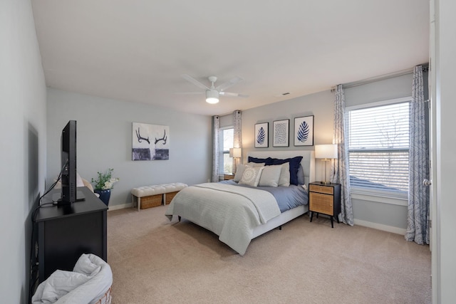 bedroom featuring baseboards, ceiling fan, and light colored carpet