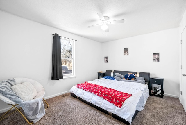 carpeted bedroom featuring a textured ceiling, a ceiling fan, and baseboards