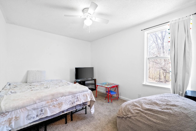 bedroom featuring carpet floors, multiple windows, baseboards, and a textured ceiling