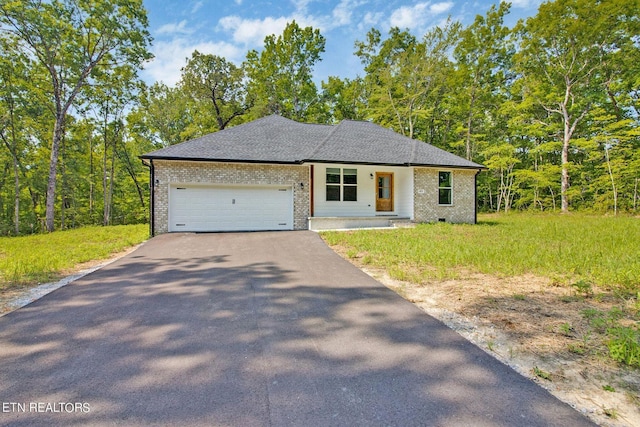 view of front of house featuring driveway, brick siding, roof with shingles, and an attached garage