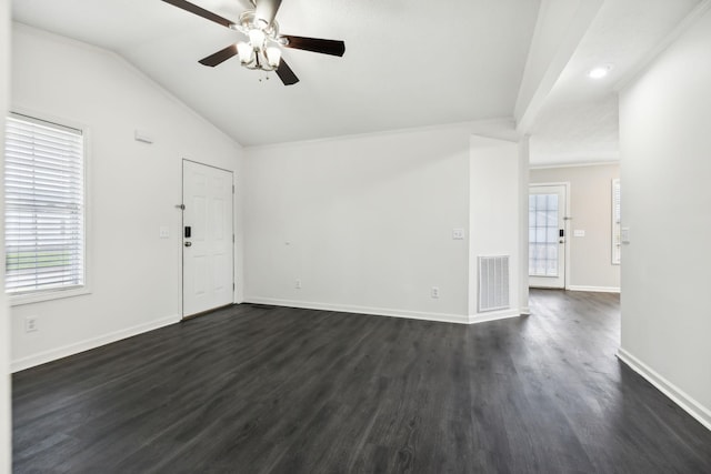 interior space with baseboards, visible vents, dark wood finished floors, a ceiling fan, and vaulted ceiling