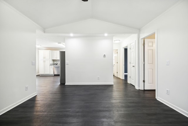 spare room with lofted ceiling, dark wood-type flooring, ornamental molding, and baseboards